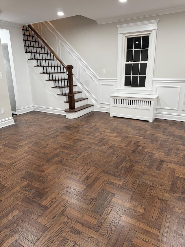 interior space with crown molding and parquet floors