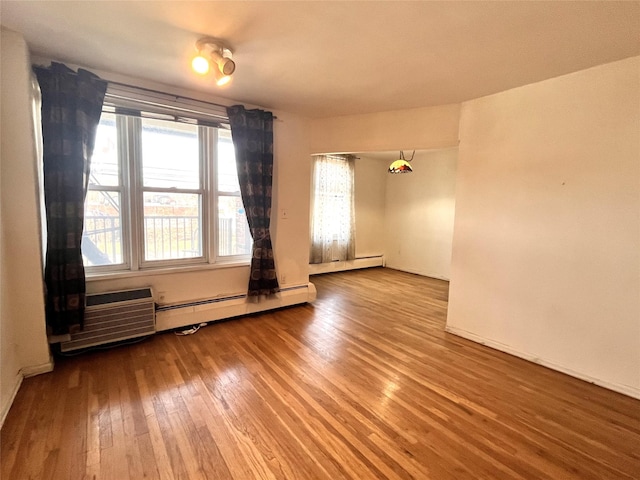 spare room featuring hardwood / wood-style floors and a healthy amount of sunlight