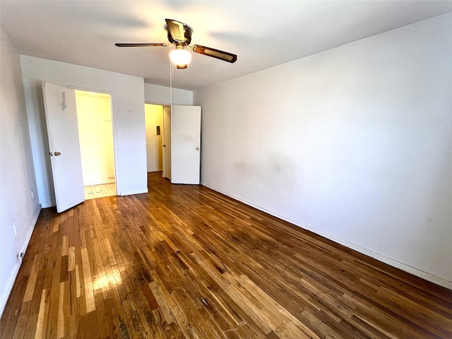 unfurnished bedroom featuring ceiling fan and dark hardwood / wood-style floors