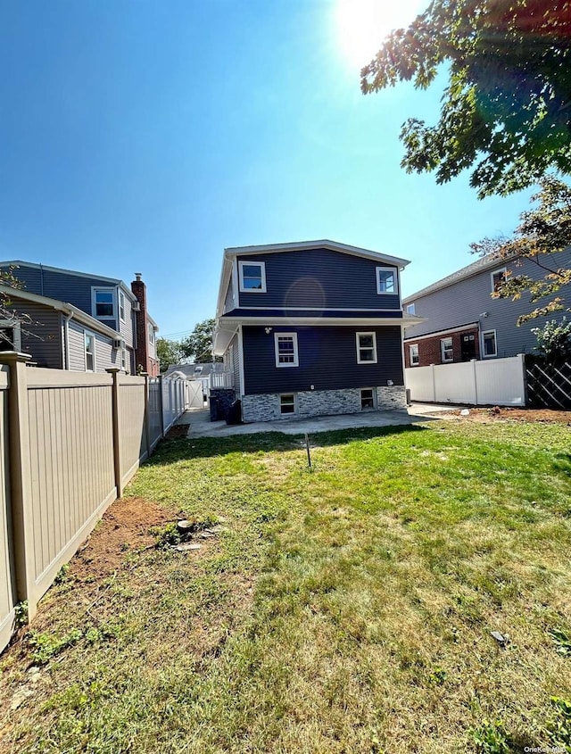 back of property featuring a patio and a yard