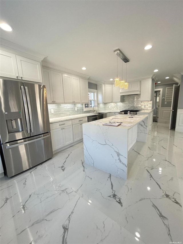 kitchen featuring white cabinetry, hanging light fixtures, a center island, and stainless steel appliances