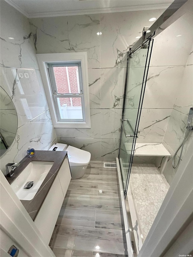 bathroom featuring toilet, vanity, tile walls, tiled shower, and ornamental molding