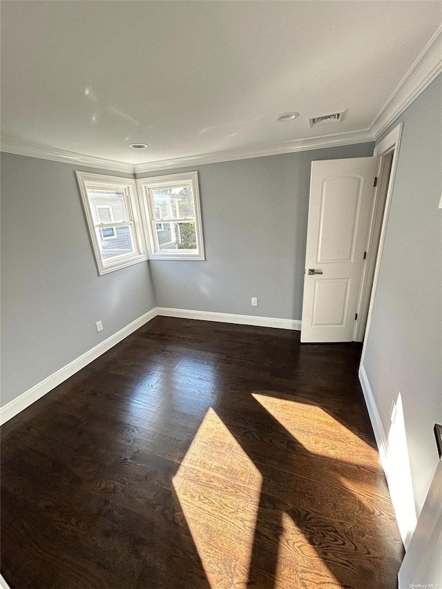 unfurnished room featuring crown molding and dark hardwood / wood-style floors