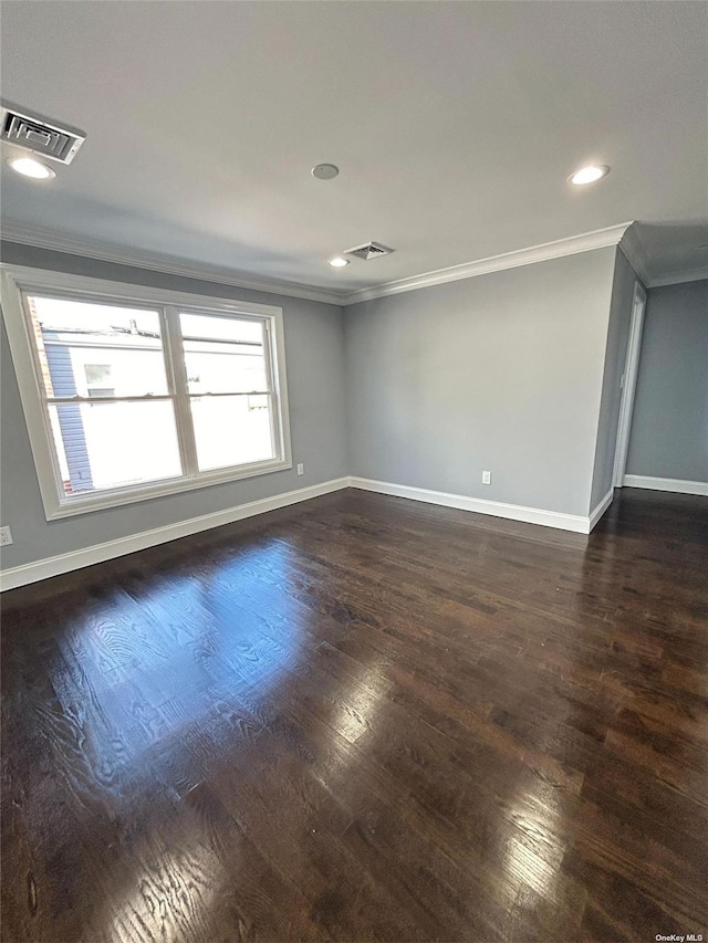 unfurnished room with dark wood-type flooring and crown molding