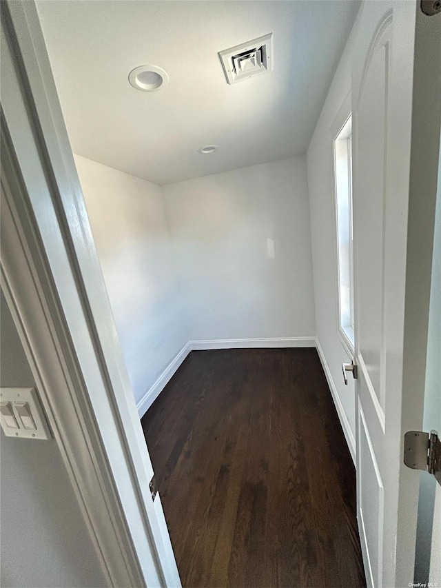 unfurnished room featuring dark hardwood / wood-style flooring