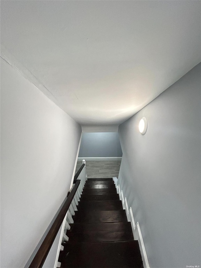 staircase with hardwood / wood-style floors