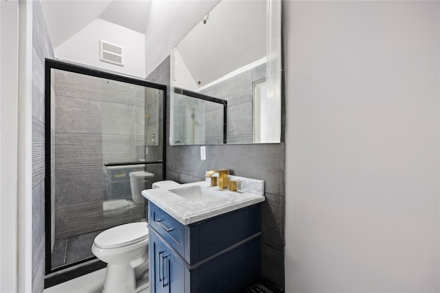 bathroom with toilet, tile walls, walk in shower, and vanity