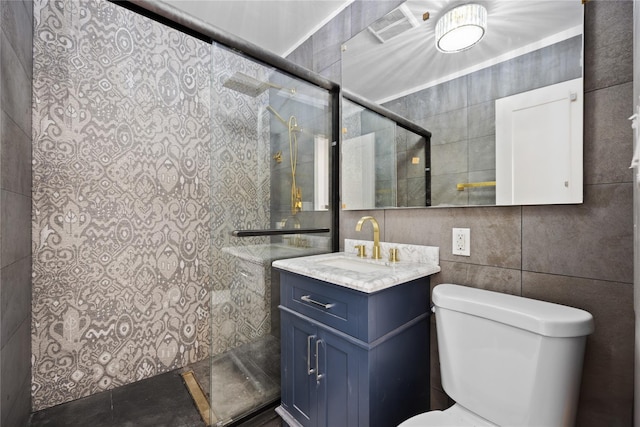 bathroom with toilet, vanity, tile walls, and a shower