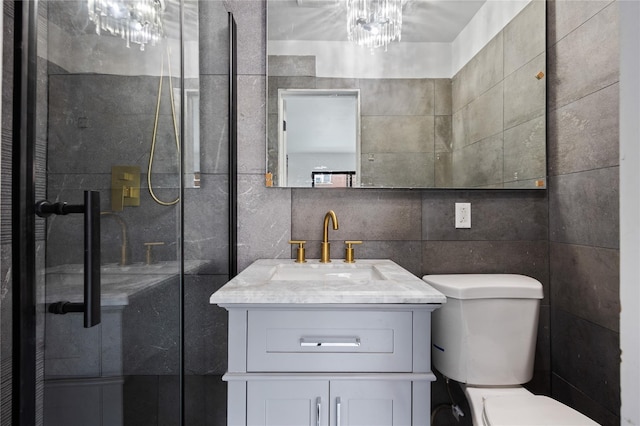 bathroom featuring tile walls, toilet, vanity, and walk in shower