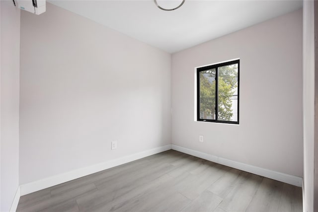 unfurnished room with light hardwood / wood-style flooring