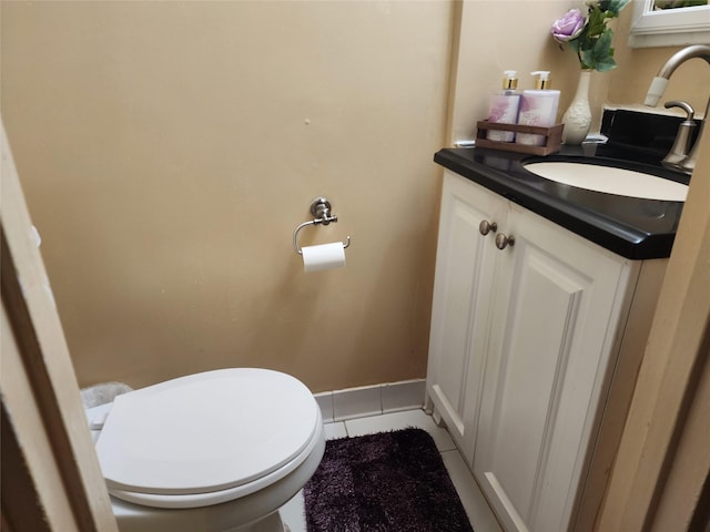 bathroom featuring toilet, tile patterned flooring, and vanity