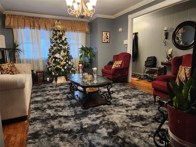 living room featuring wood-type flooring, crown molding, and a chandelier