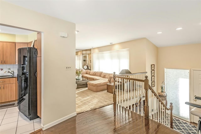 living room with light hardwood / wood-style floors and sink