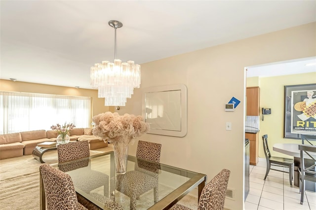 dining area featuring light tile patterned flooring and a chandelier