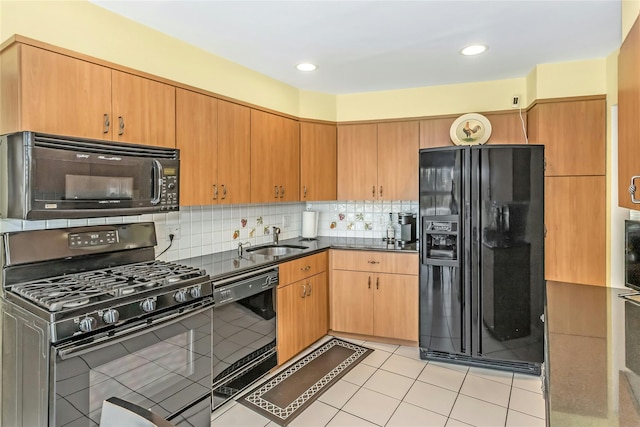 kitchen with decorative backsplash, sink, light tile patterned floors, and black appliances