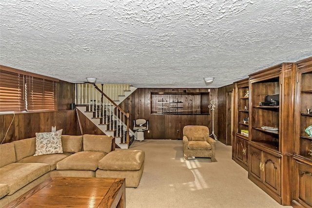 living room featuring light carpet and wood walls