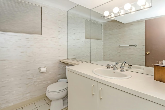 bathroom featuring toilet, tile patterned floors, and vanity