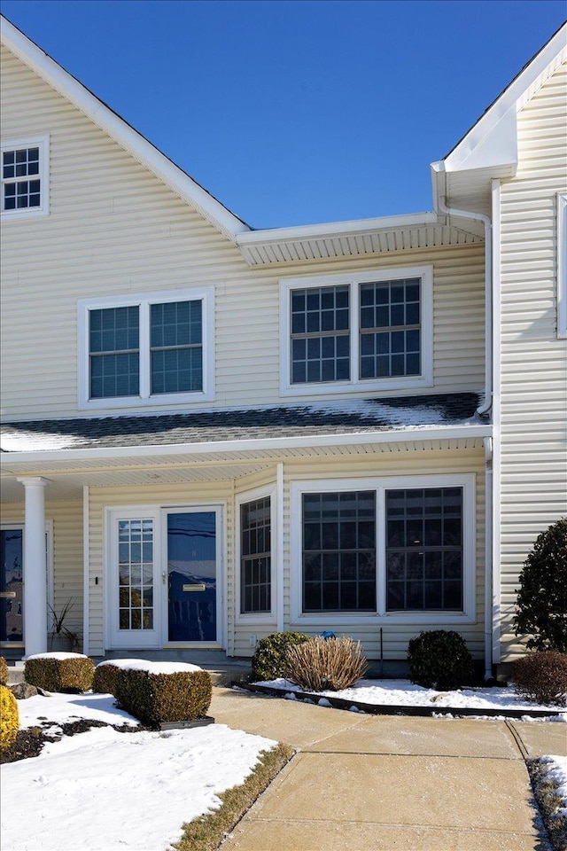 view of snow covered property entrance