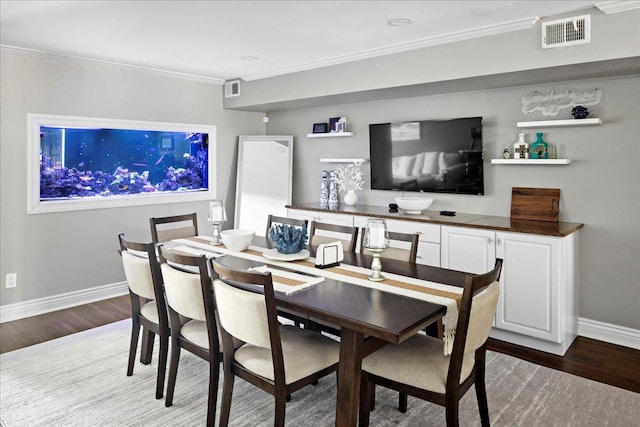 dining area with hardwood / wood-style flooring and crown molding