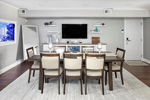 dining room featuring hardwood / wood-style floors and ornamental molding