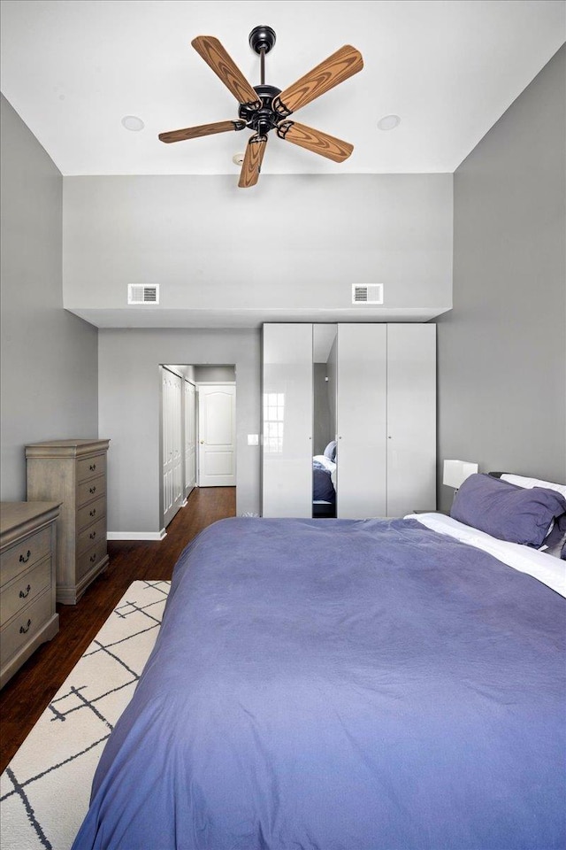 bedroom featuring a closet, ceiling fan, and dark wood-type flooring