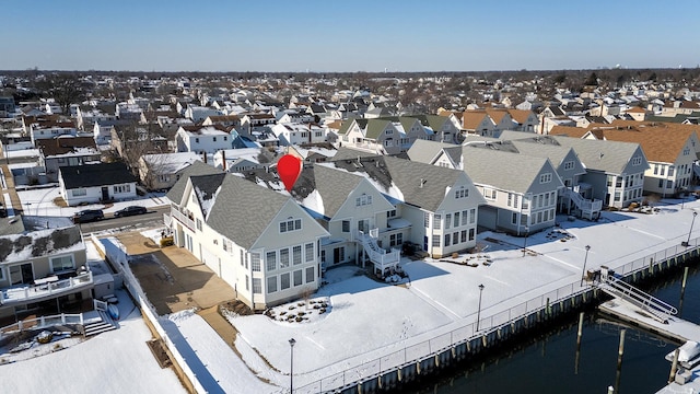 snowy aerial view with a water view