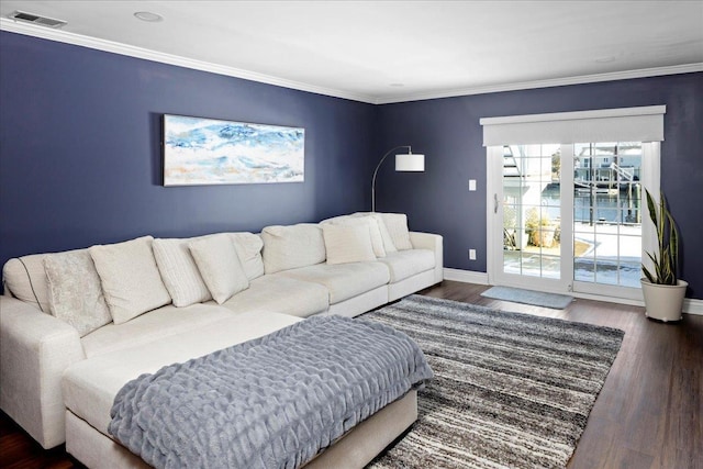 living room featuring baseboards, visible vents, dark wood finished floors, a water view, and crown molding