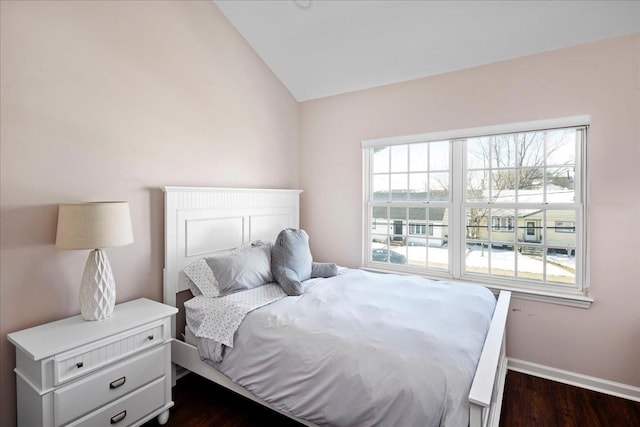 bedroom featuring baseboards, vaulted ceiling, and dark wood-style flooring