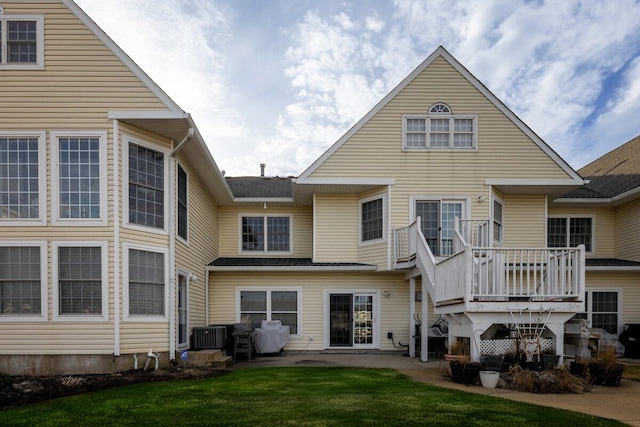 rear view of house with cooling unit, a patio area, and a yard