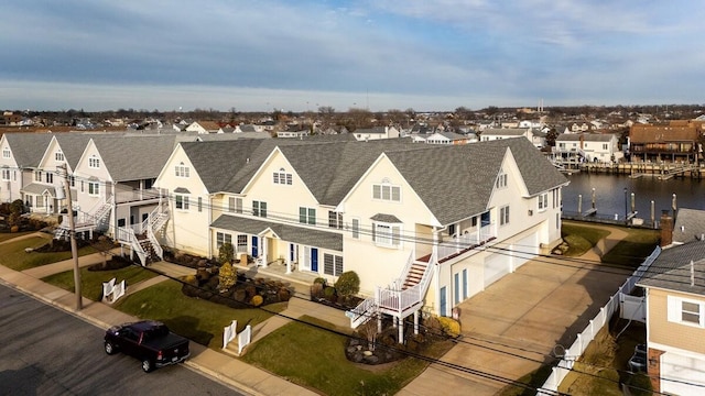 bird's eye view with a water view and a residential view