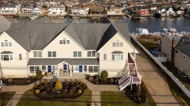 exterior space featuring a water view and a residential view