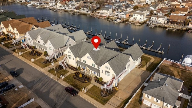 drone / aerial view featuring a water view and a residential view