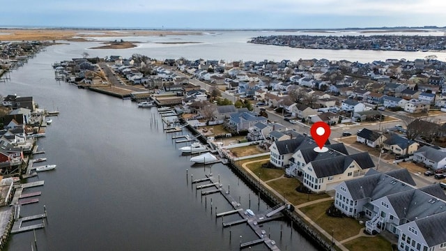 drone / aerial view with a water view and a residential view