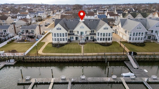 birds eye view of property with a water view and a residential view