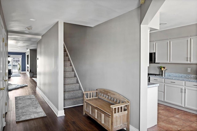 stairs featuring recessed lighting, wood finished floors, and baseboards