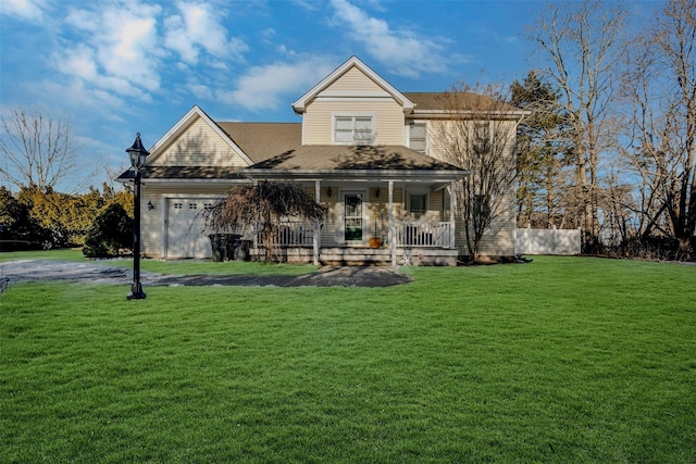 view of front of home with a garage, covered porch, and a front lawn