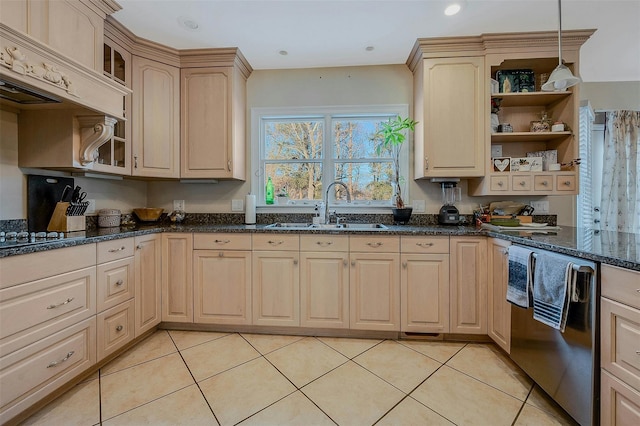 kitchen with light brown cabinetry, sink, decorative light fixtures, light tile patterned floors, and dark stone counters