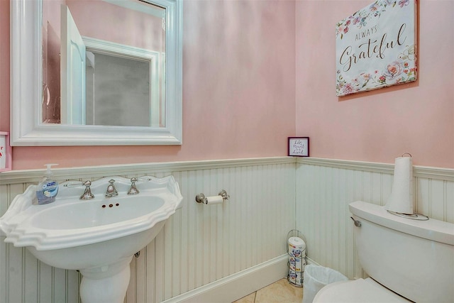 bathroom featuring tile patterned flooring, sink, and toilet