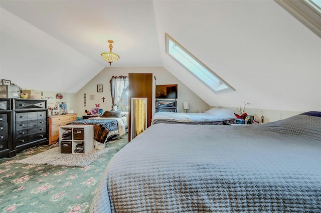 carpeted bedroom featuring lofted ceiling with skylight