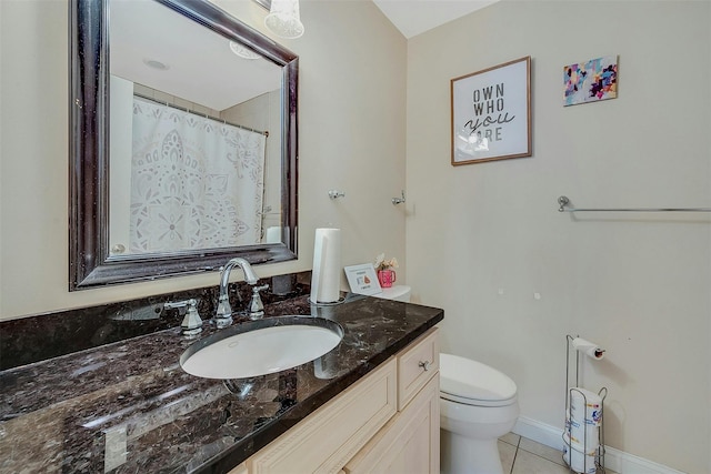 bathroom with tile patterned floors, toilet, and vanity