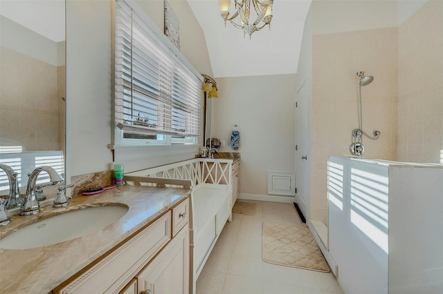 bathroom with sink, vaulted ceiling, and a chandelier