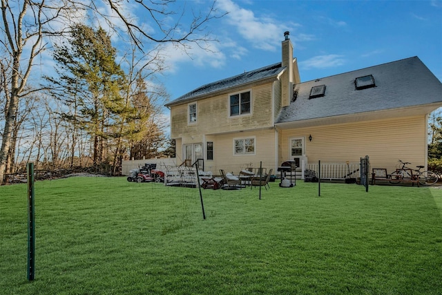 back of house featuring a yard