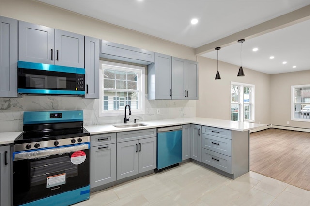 kitchen with tasteful backsplash, decorative light fixtures, kitchen peninsula, sink, and stainless steel appliances