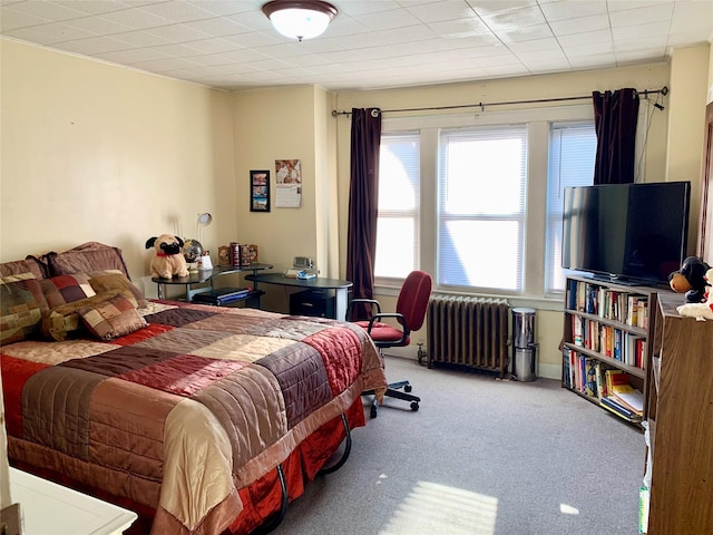 carpeted bedroom with radiator