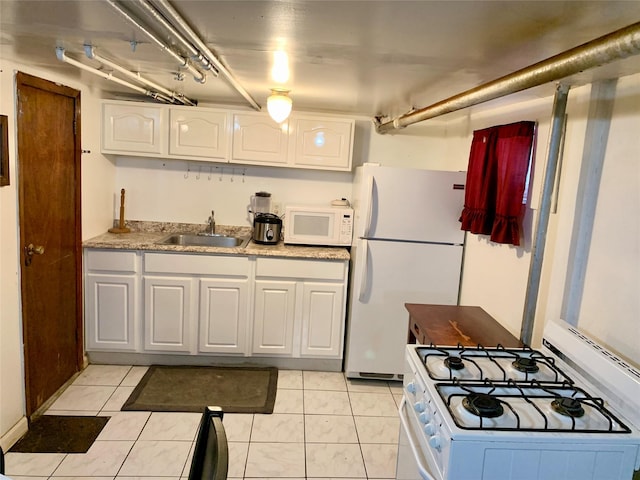 kitchen featuring white cabinets, sink, light tile patterned floors, and white appliances