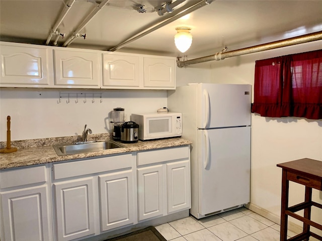 kitchen with white cabinetry, sink, white appliances, and light tile patterned floors