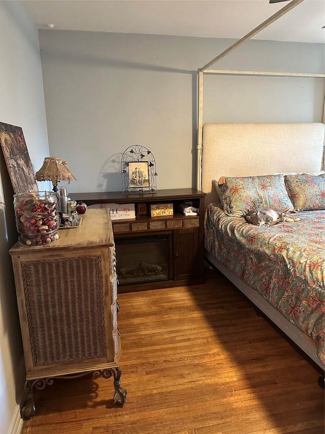 bedroom with hardwood / wood-style flooring