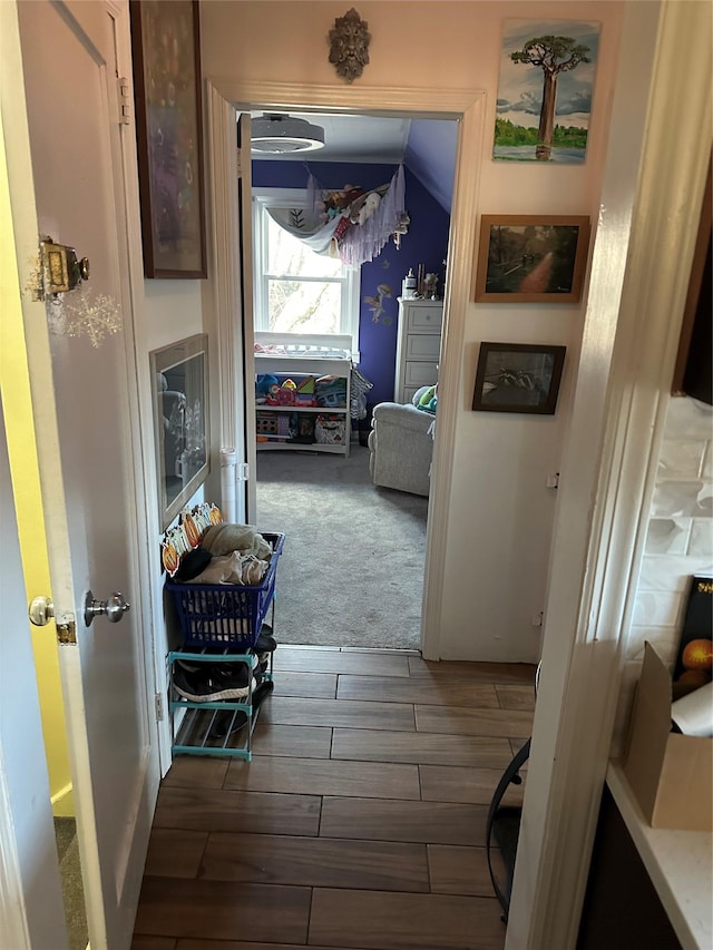 corridor with dark hardwood / wood-style flooring