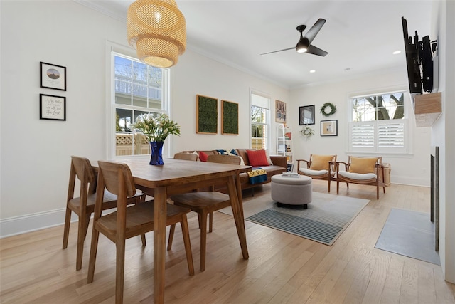 dining area featuring ornamental molding, a healthy amount of sunlight, and light wood-type flooring