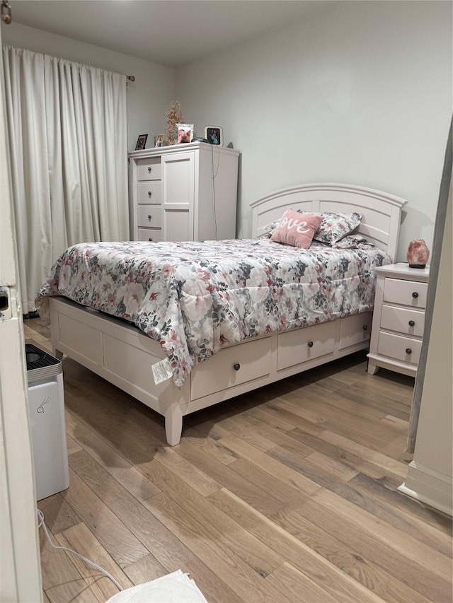 bedroom with wood-type flooring